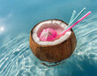 Coconut cocktail in a blue glass with a straw in the pool or
Coconut cocktail with ice cream on the background of the sea