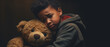 Young Boy Holding His Teddy Bear in a Dark Room