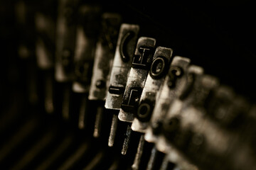 Closeup of old typewriter plates strikers strykers with letters and symbols for typing.