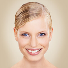 Poster - Portrait, smile for beauty and woman with blue eyes in studio on beige background for natural wellness. Face, skincare and aesthetic with happy young model at spa for makeup, cosmetics or dermatology