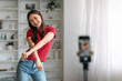 © Prostock-studio - Blogging Concept. Cheerful Asian Woman Dancing At Camera At Home
