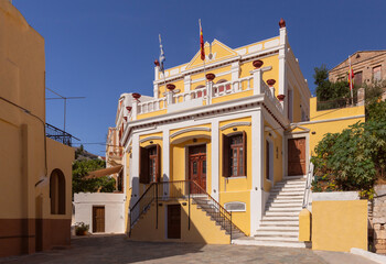 Wall Mural - Multi-colored facades of houses in the Greek village Symi on a sunny day