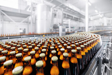 Wall Mural - Brewery conveyor on modern alcohol drink production line. Brown glass beer bottles on industry plant.