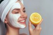 Cosmetology, skin care, face treatment, spa and natural beauty concept. Woman with facial mask holds lemon, over white background with copy space.