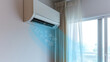 Air conditioner in beautiful interior above the sofa, bed near the window emitting cold air