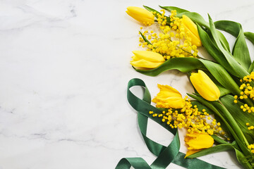 Wall Mural - Greeting for International Women's Day on March 8th. Branches of mimosa and yellow tulips.