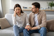 © Prostock-studio - Concerned young man comforting upset woman on couch