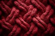 Closeup of a Carmine knitted fabric with a intricate braided pattern