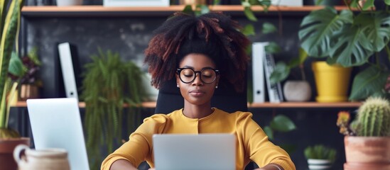 Poster - professional woman working at her desk using a modern laptop and typing on keyboard in a contemporar