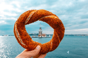 Wall Mural - Bagel and Maiden's Tower. Bagel in the front, Maiden's Tower blurred in the background. Magnificent photo of the Maiden's Tower inside a bagel. Istanbul Turkey.