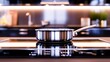  metal shiny pan on an induction stove against the background of a blurred image of the kitchen 
