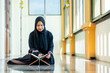 © maya1313 - Ramadan, The image of an Asian Muslim woman in the Islamic religion in hijab in black color. reading the Quran and having a happy smiling face Staying in a beautiful mosque out of respect for God.