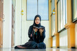 © maya1313 - Ramadan, The image of an Asian Muslim woman in the Islamic religion in hijab in black color. reading the Quran and having a happy smiling face Staying in a beautiful mosque out of respect for God.