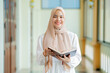 © maya1313 - Ramadan, quran, The image of an Asian Muslim woman in the Islamic religion in hijab in cream color. reading the Quran and having a happy Staying in a beautiful mosque, Arabic word Holy Al Quran.