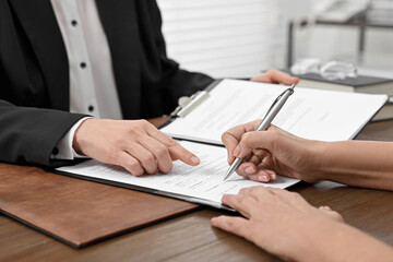 Sticker - Senior woman signing document in lawyer's office, closeup