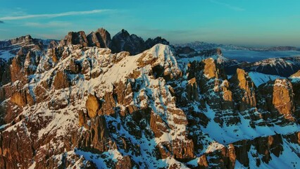 Wall Mural - Aerial view of amazing rocky mountains in snow at sunrise, Dolomites, Italy, 4k