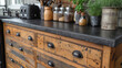 A rustic farmhouse kitchen renovation showcases black metal cabinet pulls and hinges perfectly complementing the distressed wood cabinets and giving the space a charming and