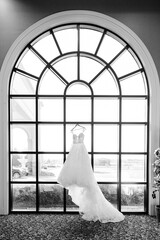 Wall Mural - wedding dress hanging in window