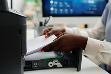 Medium Closeup Of Hands Of Unrecognizable African American Female Office Worker Filling Printer Tray With Sheets Of Paper