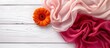 Beautiful pink floral arrangement with soft scarf on rustic white wooden background