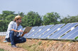 © kamonrat - Farmers check the operation of solar cell panels for farming. Modern agriculture. Clean energy.