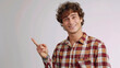 © AI Visual Vault - Casual Man Pointing Sideways.Relaxed man in a checkered shirt pointing sideways.