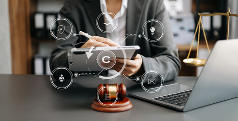 Wall Mural - Copyright or patent concept, Person hand using laptop computer, tablet and smartphone with virtual screen copyright icon trademark, Creation ownership against piracy. .