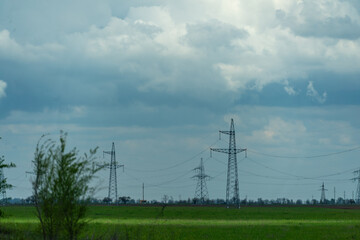 High voltage towers with sky background. Power line support with wires for electricity transmission. High voltage grid tower with wire cable at distribution station. Energy industry, energy saving