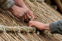 Thatch Roof Detail With Roofers Hands Tying Knots
