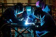 team of welders collaboratively joining a metal framework