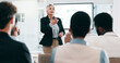 © peopleimages.com - Business people, feedback and woman with presentation, seminar and questions with partnership, corporate training and discussion. Presenter, speaker and audience in a workshop, learning and crowd