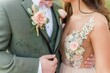 couple matching corsage and boutonniere on outfits