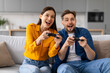 © Prostock-studio - Excited young couple playing video games together on couch