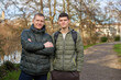 © andreiko - Father-Son Bond: Handsome 40-Year-Old Man and 17-Year-Old Son Standing Together in Winter or Autumn Park.