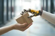 © lucky pics - robot hand giving cardboard box to human hand