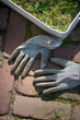 © Connect Images - Gardening gloves and a bucket of weeds on a path