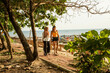 © Connect Images - Two young women friends one wearing hijab, walk along the coastal path in southern Thailand