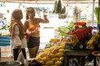 © Connect Images - Two young women one wearing a hijab  in a fruit shop in Thailand.