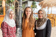 © Connect Images - Portrait of three women friends, two wearing hijab in a coastal town in southern Thailand.