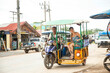 © Connect Images - Young female solo traveller riding in a TukTuk
