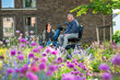 © Connect Images - Close up shot of a man in a electric wheelchair accompanied by his wife walking down the street happy and laughing together