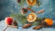 christmas tree branches pine cone dried oranges and apples cinnamon levitating on a blue background winter and holidays inspiration