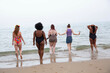 © Connect Images - A mixed group of female friends having fun at the beach.