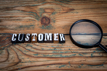 Wall Mural - CUSTOMER. Alphabet letters on wood texture background