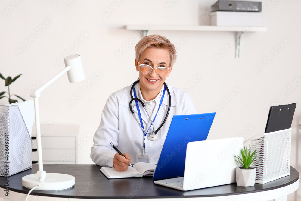 Mature female doctor working  in clinic