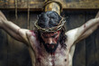 Jesucristo crucificado sobre la cruz de madera, con la corona de espinas sobre su cabeza, cara ensangrentada y torso desnudo. Concepto celebraciones, Semana Santa, Pascua, 