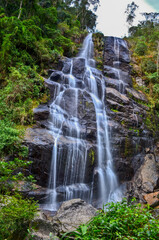 Wall Mural - Véu da Noiva (Bridal Veil) waterfall surrounded by the lush subtropical montane rainforest of the lower sector of Itatiaia National Park, Itatiaia, Rio de Janeiro, Brazil.