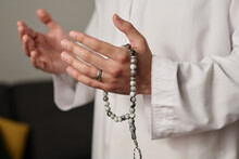 Hands Of Unrecognizable Man In White Thwab Holding Rosary Beads During Silent Pray Or While Worshipping Allah On Religious Occasion