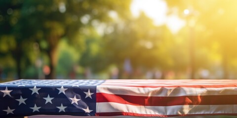 Poster - American flag displayed on a table in a park. Perfect for patriotic events and celebrations