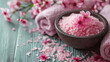 Spa still life with pink bath salt and flowers.